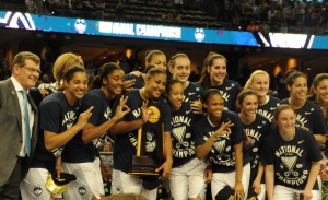 The UConn women's basketball team celebrates winning their third consecutive National Championship.